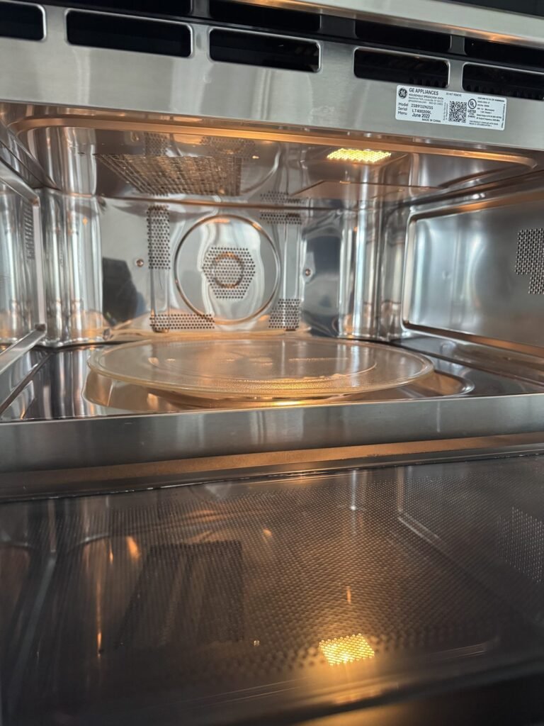 Clean stainless microwave cavity with a clear inner door panel after JenyClean kitchen deep cleaning in Bellevue, WA