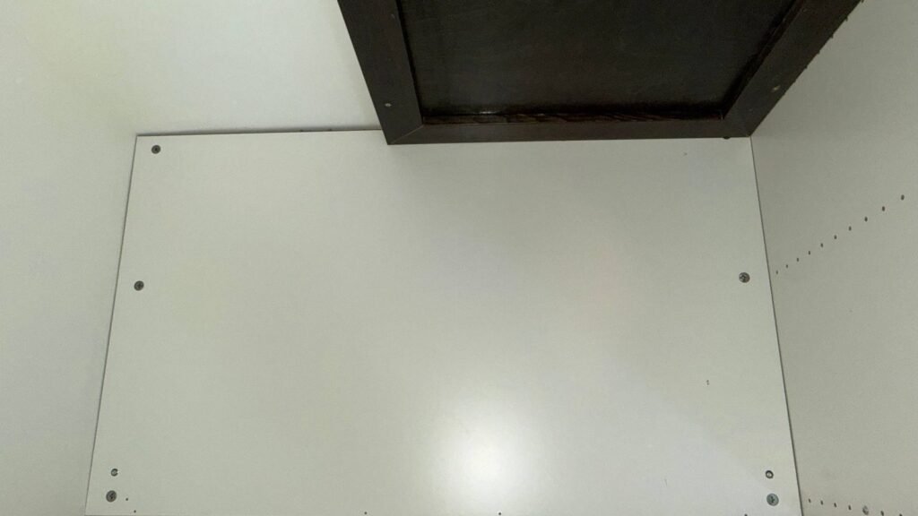 Clean white under-sink cabinet panel after JenyClean deep cleaning in Bothell, WA