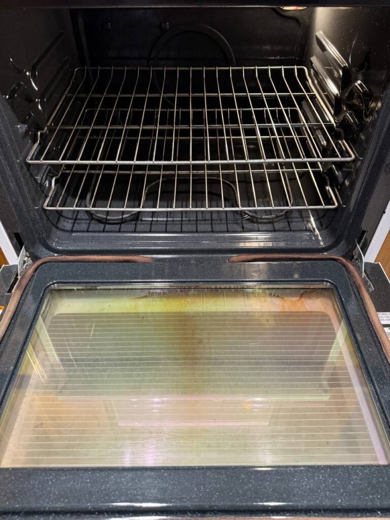 Clean oven interior with bare enamel floor after JenyClean deep cleaning in Bothell, WA