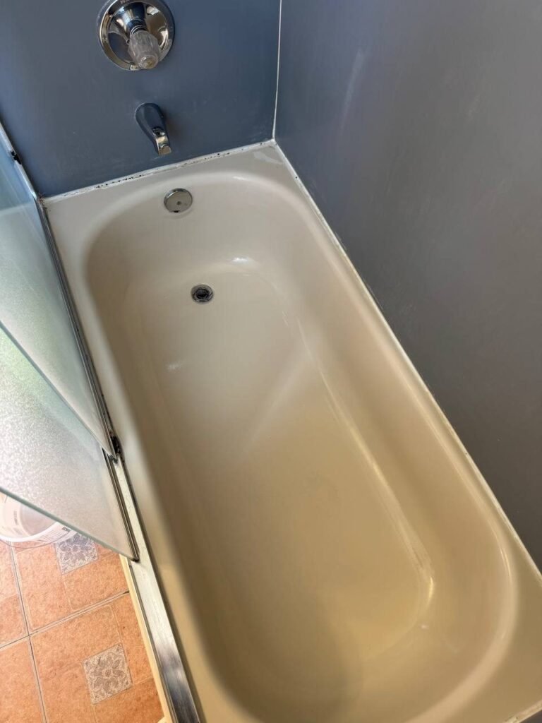 Clean cream enamel bathtub with no rust after JenyClean bathroom deep cleaning in Bothell, WA