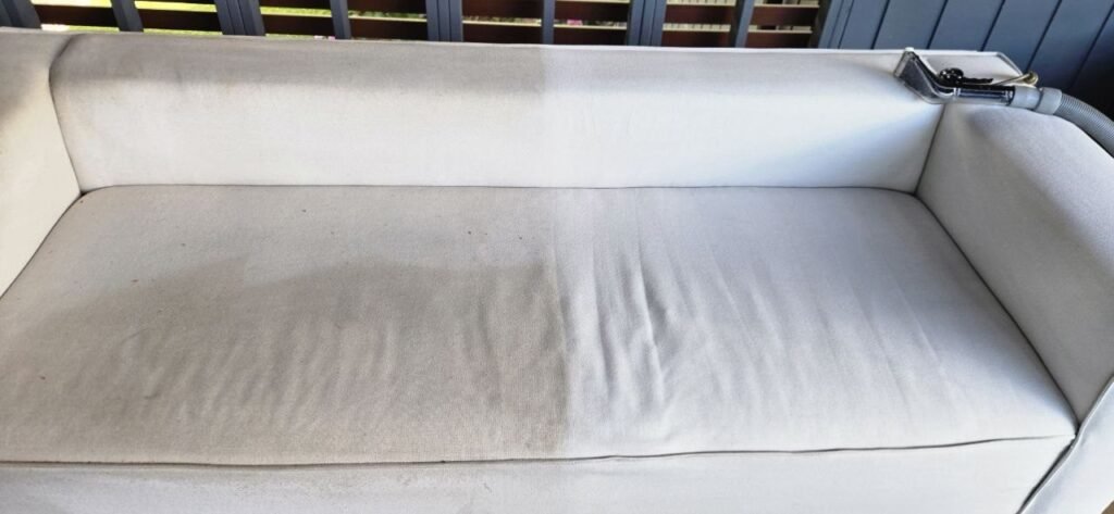 Light patio sofa seat half cleaned and half gray during JenyClean upholstery cleaning in Kirkland, WA