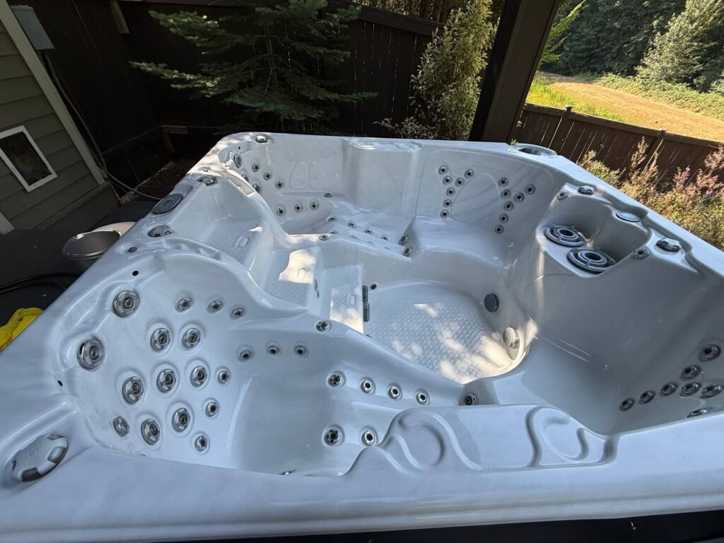 Empty, clean white hot tub shell with jets visible after JenyClean cleaning in Redmond, WA