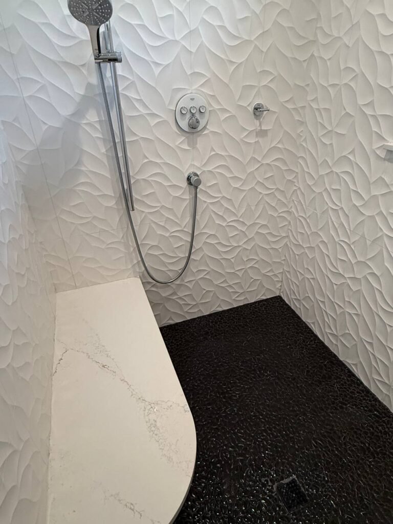 Shower room with clean white textured tile and chrome rail after JenyClean deep cleaning in Redmond, WA