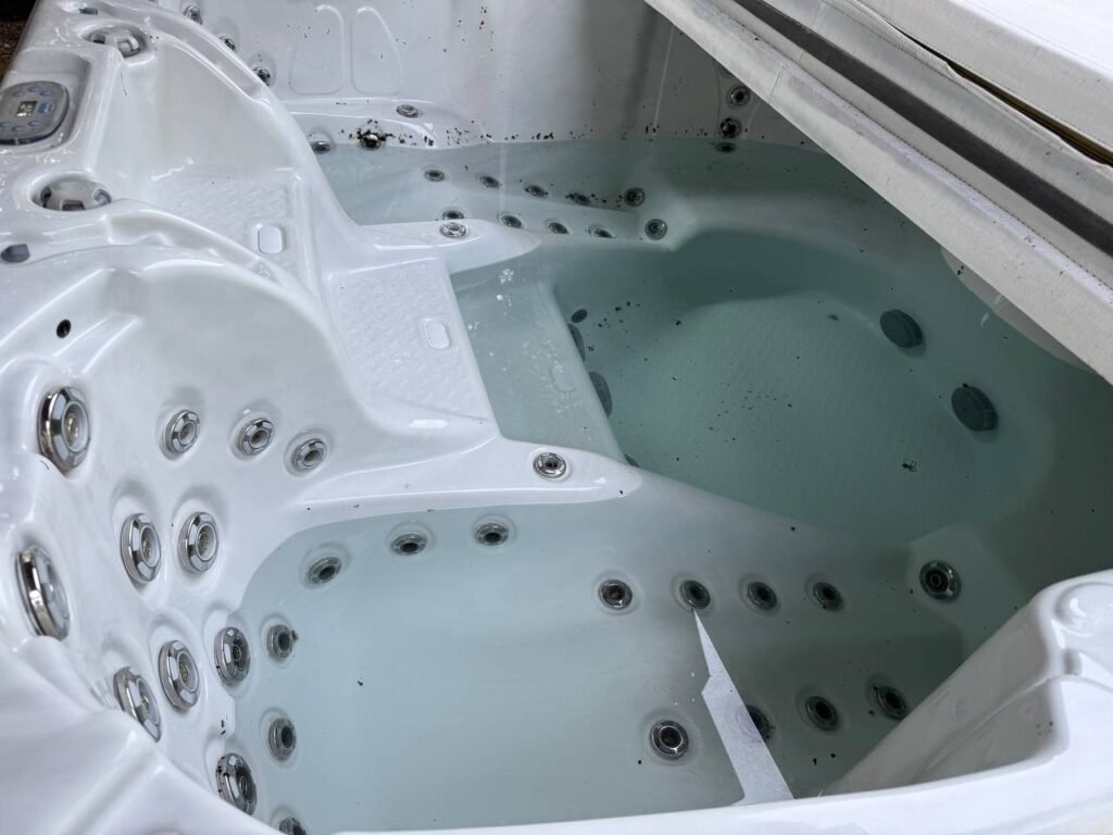 Outdoor hot tub full of cloudy water before JenyClean cleaning in Redmond, WA