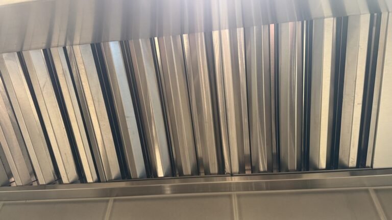 Clean silver baffle filters back in the range hood after JenyClean kitchen deep cleaning in Redmond, WA