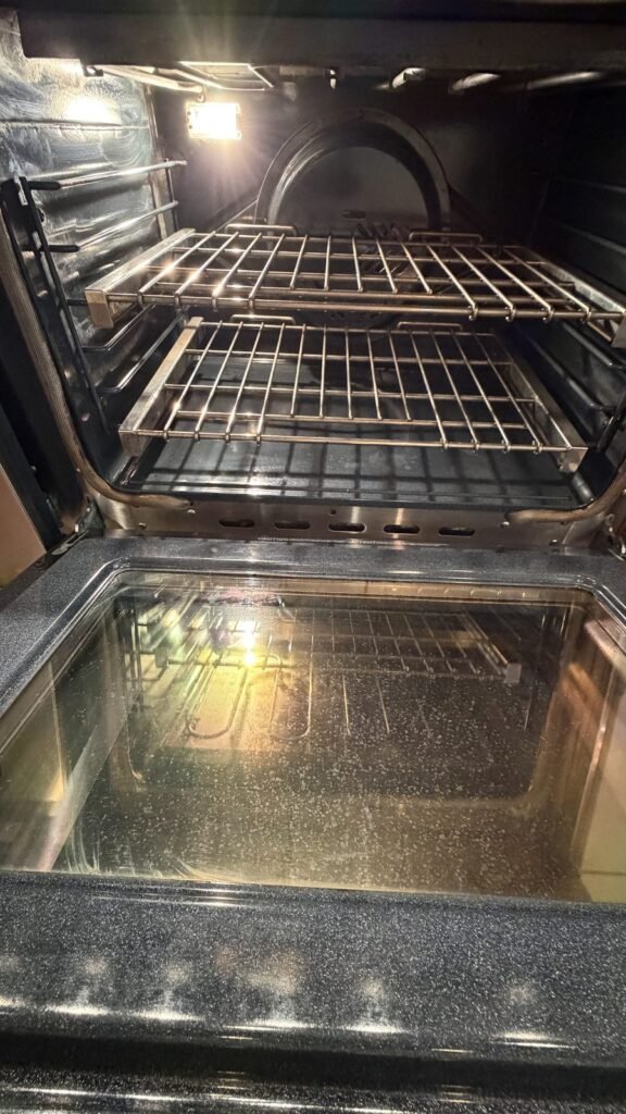 Oven with clear inner door glass and a clean floor after JenyClean kitchen deep cleaning in Redmond, WA