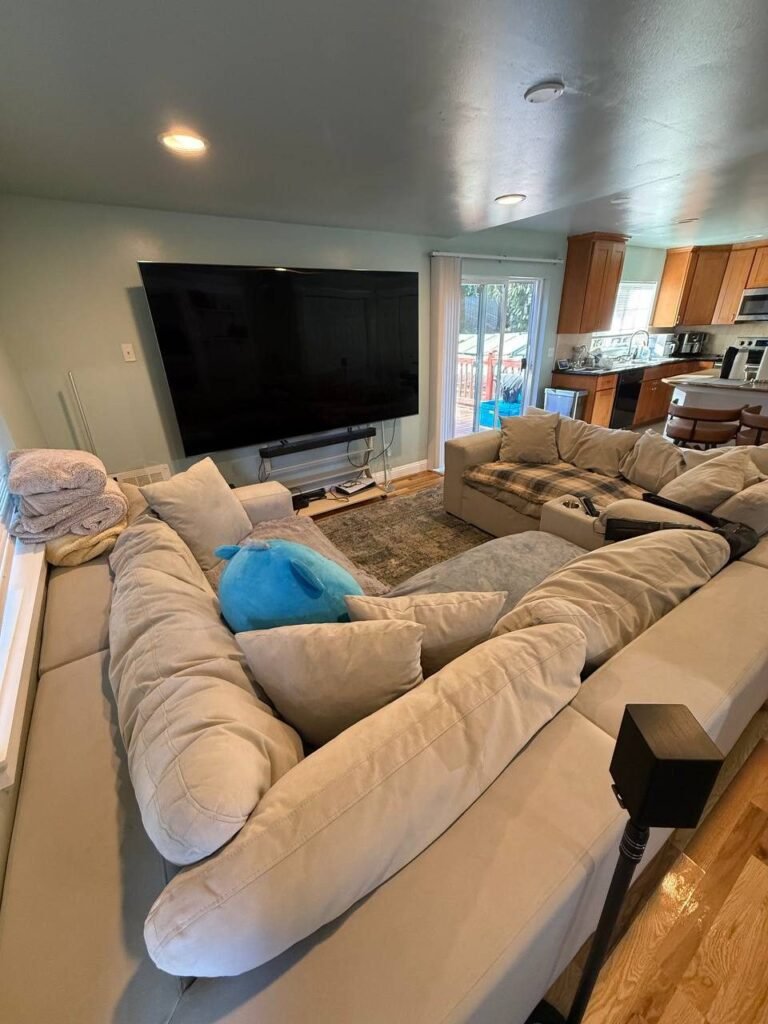 Same sectional sofa with cushions arranged and throws folded after JenyClean monthly cleaning in Redmond, WA