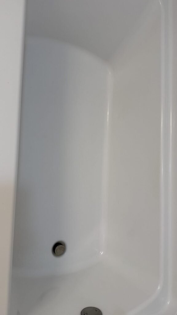 Bright white bathtub basin with clean drain after JenyClean regular cleaning in Renton, WA