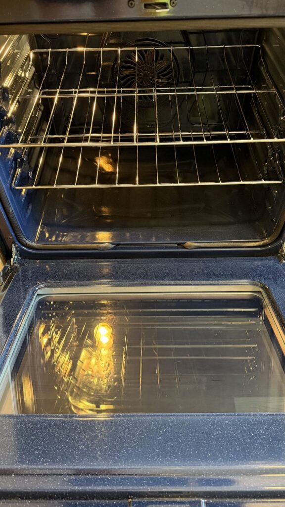 Clean oven interior with shiny racks, clear door glass and convection fan visible after JenyClean oven cleaning in Renton, WA