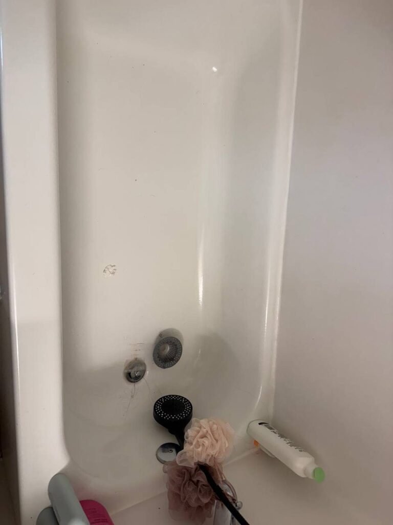 Bathtub with hair around the overflow and drain before JenyClean same-day house cleaning in Renton, WA