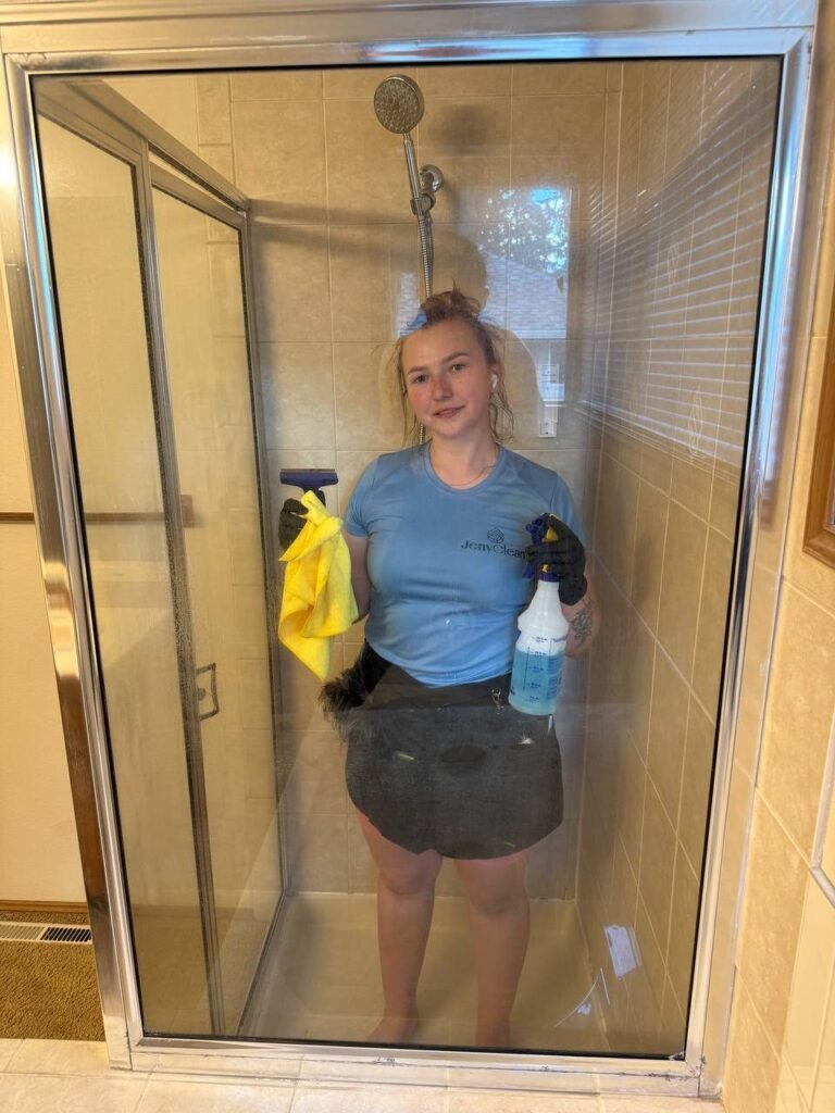 Clear glass shower enclosure with the cleaner fully visible behind it after JenyClean bathroom cleaning in Sammamish, WA