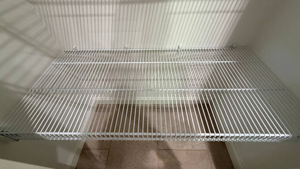 Same white wire shelf clean and bright with a clean tile floor below after JenyClean move-in cleaning in Sammamish, WA