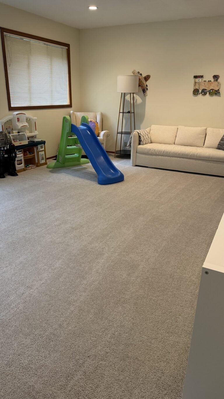 Clear, freshly vacuumed playroom carpet with the slide by the armchair after JenyClean cleaning and organizing in Sammamish, WA