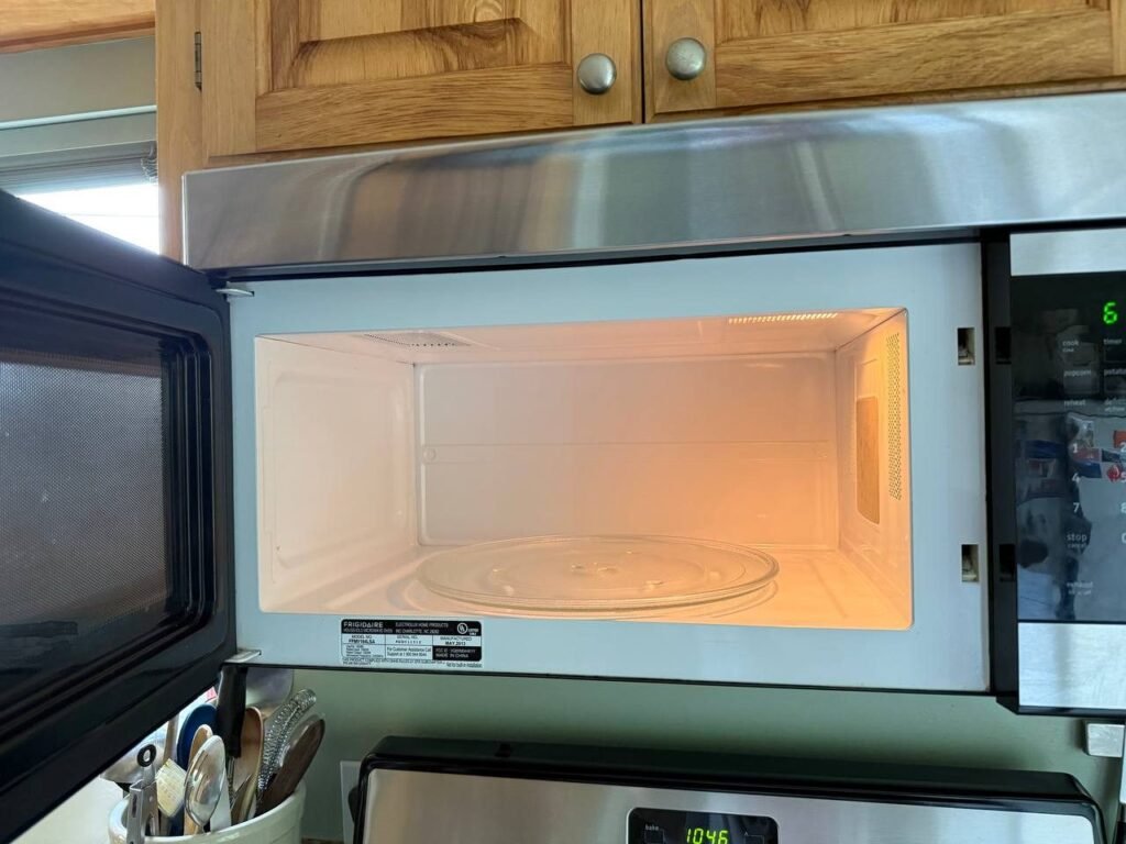 Clean white microwave interior and glass turntable after JenyClean kitchen cleaning in Seattle, WA