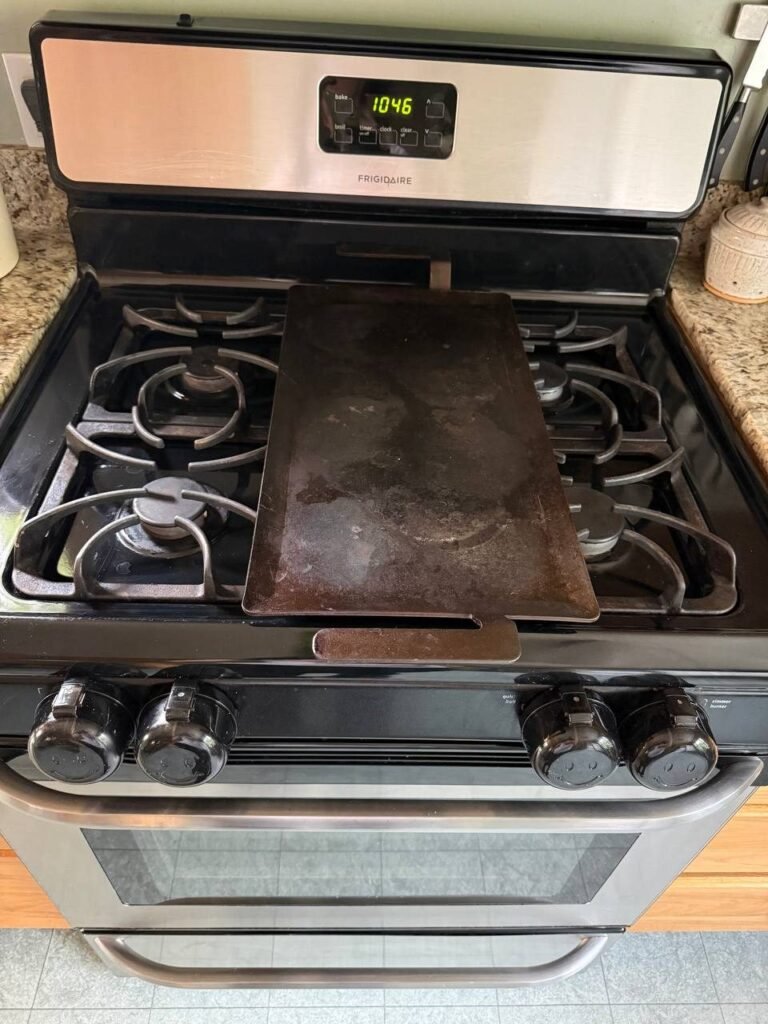 Gas stove with clean grates and a cleared griddle pan after JenyClean kitchen cleaning in Seattle, WA