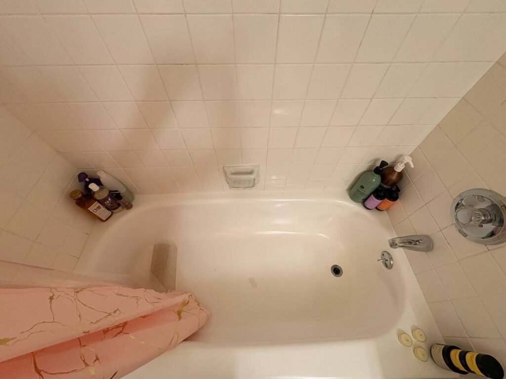 Clean white bathtub, chrome faucet and lighter grout lines after JenyClean bathroom cleaning in Seattle, WA