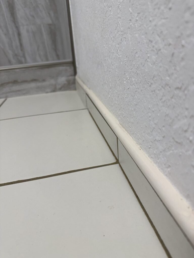Clean white baseboard and floor joint along a wall after JenyClean deep cleaning in Seattle, WA