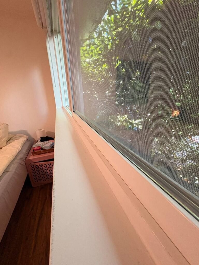 Same bedroom window with a clean track, frame and sill after JenyClean deep cleaning in Seattle, WA