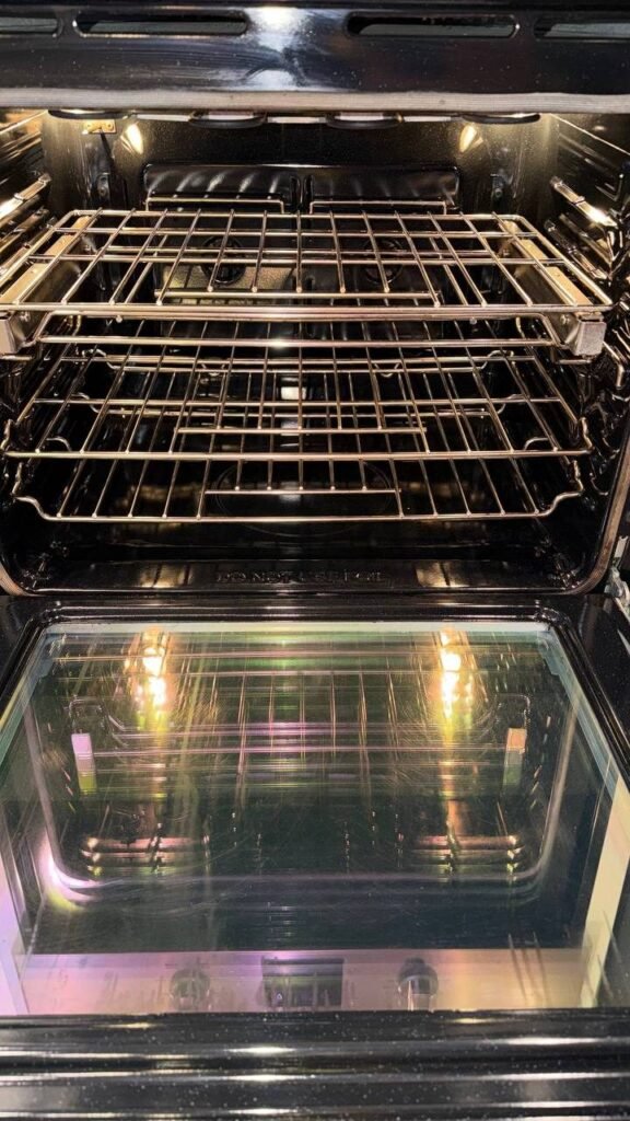 Clean oven interior with bright racks and clear door glass after JenyClean detailed cleaning in Seattle, WA