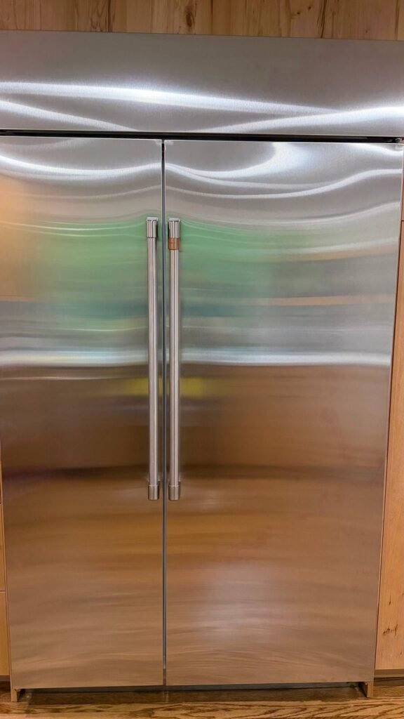 Built-in stainless refrigerator with two clean full-height doors after JenyClean regular cleaning in Seattle, WA