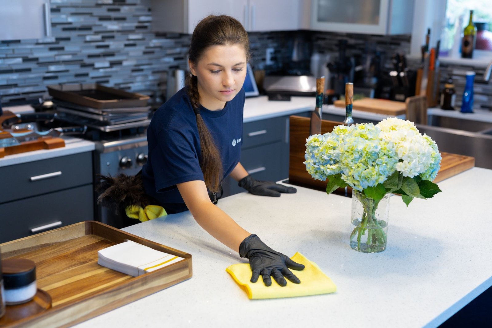 JenyClean cleaner wiping a kitchen countertop