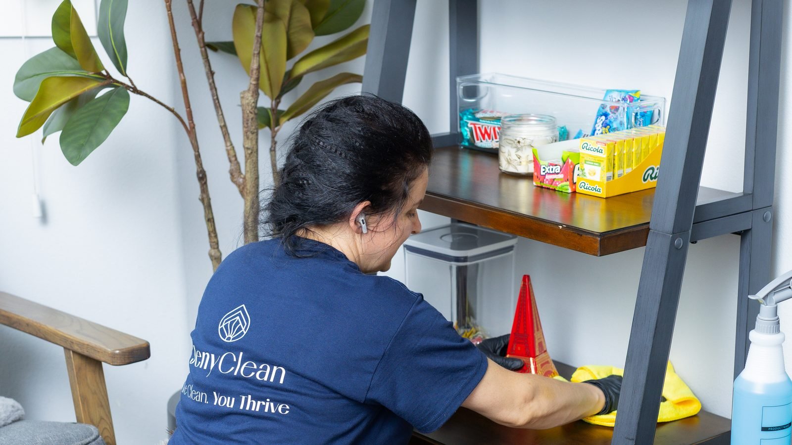 JenyClean cleaner wiping a shelf with snacks and containers