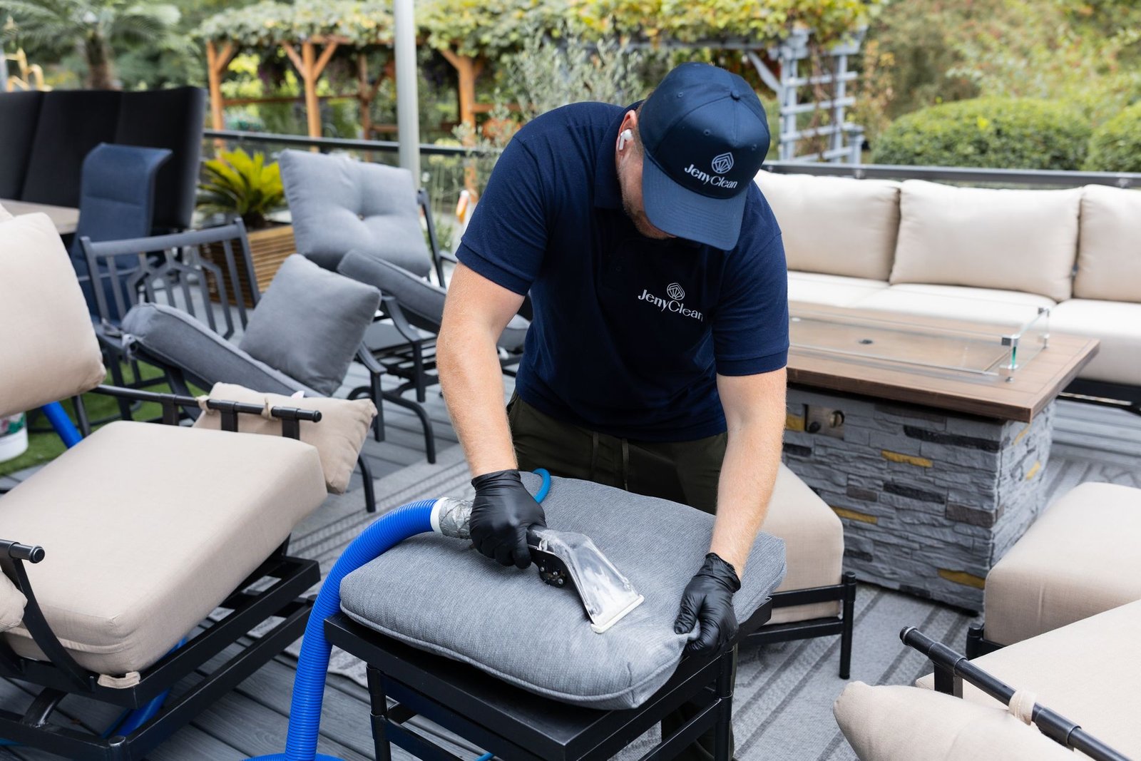 JenyClean technician steam cleaning an outdoor furniture cushion